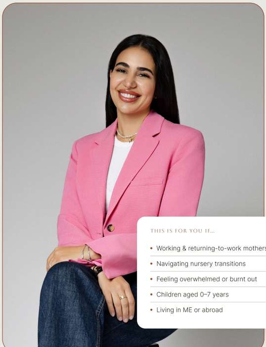Lama smiling in a pink blazer